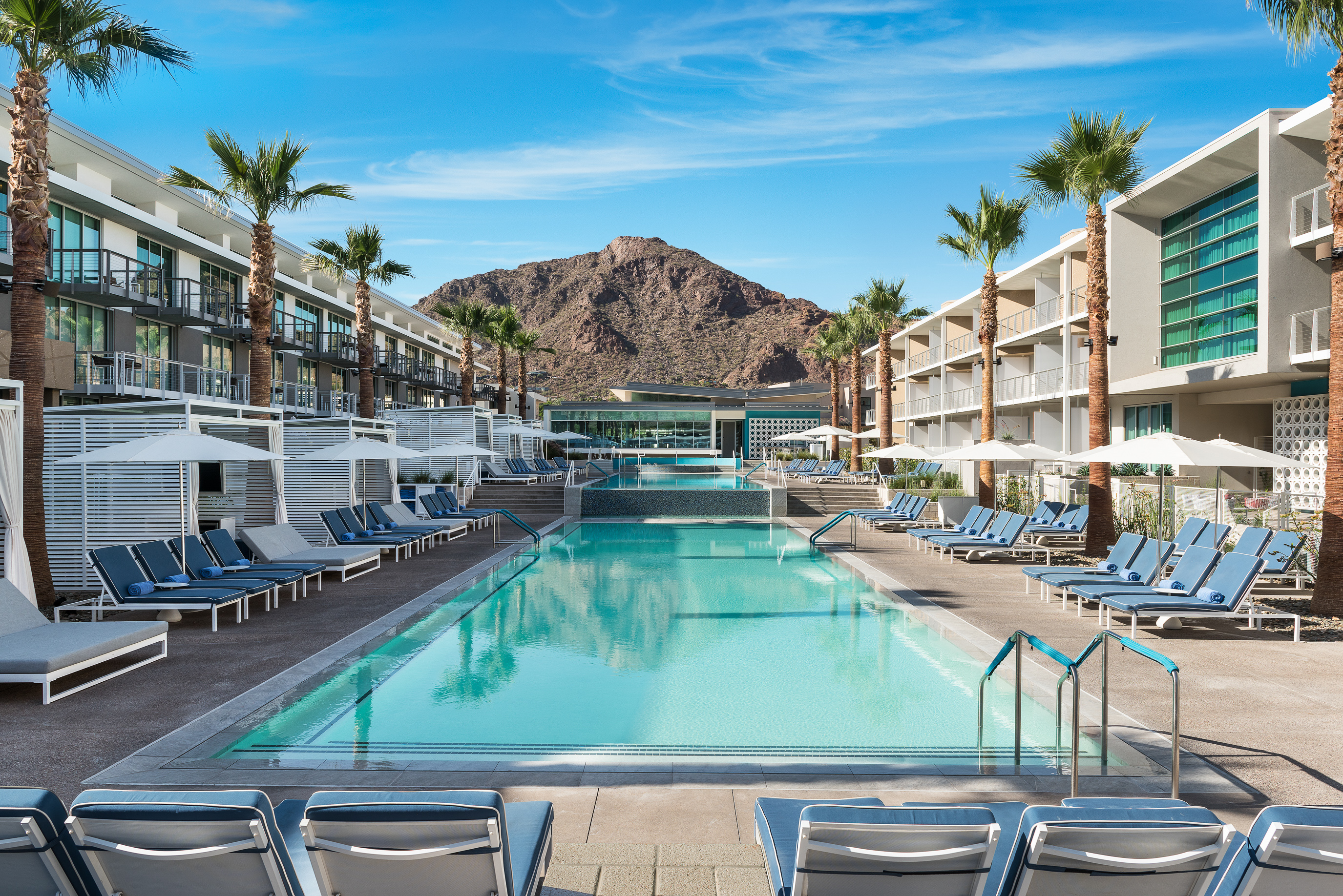 Pool Area With Lounge Chairs, Cabanas, Palm Trees, And Camelback Mountain View