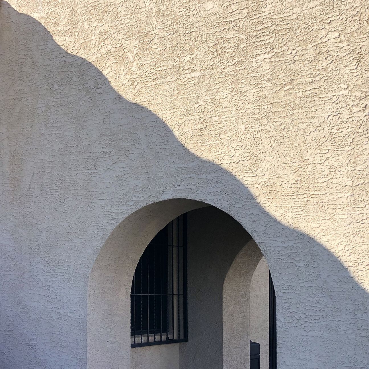 shadow on concrete wall with arch